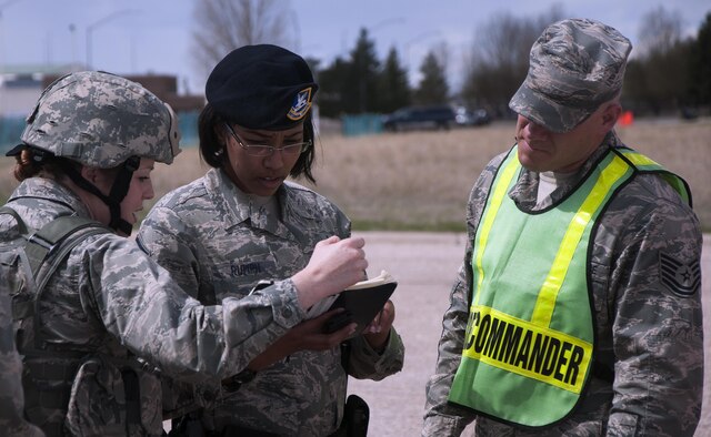 First Lt. Brittnay Taboada, 90th Security Forces Squadron, briefs the security forces on-scene commander, Master Sgt. Kimberly Rumph, and the incident commander, Tech. Sgt. Garey Schmidt, during an exercise on F.E. Warren Air Force Base, Wyoming, April 13, 2016. Security forces were the first to arrive at the staging area and handed off control to the incident commander once the scene was secure. (U.S. Air Force photo by Senior Airman Brandon Valle)