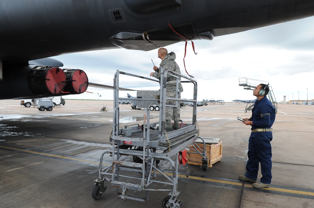 U.S. Air Force Tech. Sgt. Ross Perry, 7th Aircraft Maintenance Squadron electronic warfare noncommissioned officer in charge, left, and Airman 1st Class Terrance Boykins, 7th AMXS crew chief, work on a B-1B Lancer April 9, 2016, at Dyess Air Force Base, Texas. Perry and Boykins participated in Exercise Constant Vigilance 16, which tests the Air Force Global Strike Command’s ability to respond quickly and effectively in a real-world situation. (U.S. Air Force photo by Senior Airman Shannon Hall/Released)