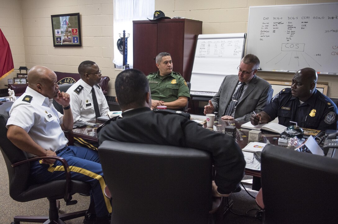 Command Sgt. Maj. Craig Owens (left), senior enlisted advisor, and Maj. Gen. Phillip Churn, commanding general of the 200th Military Police Command, meet with senior leaders of the Customs and Border Protection's National Frontline Recruitment Command, for a discussion about careers available to U.S. Army Reserve Soldiers, April 15, at the MP's headquarters, Fort Meade, Maryland. (U.S. Army photo by Master Sgt. Michel Sauret)