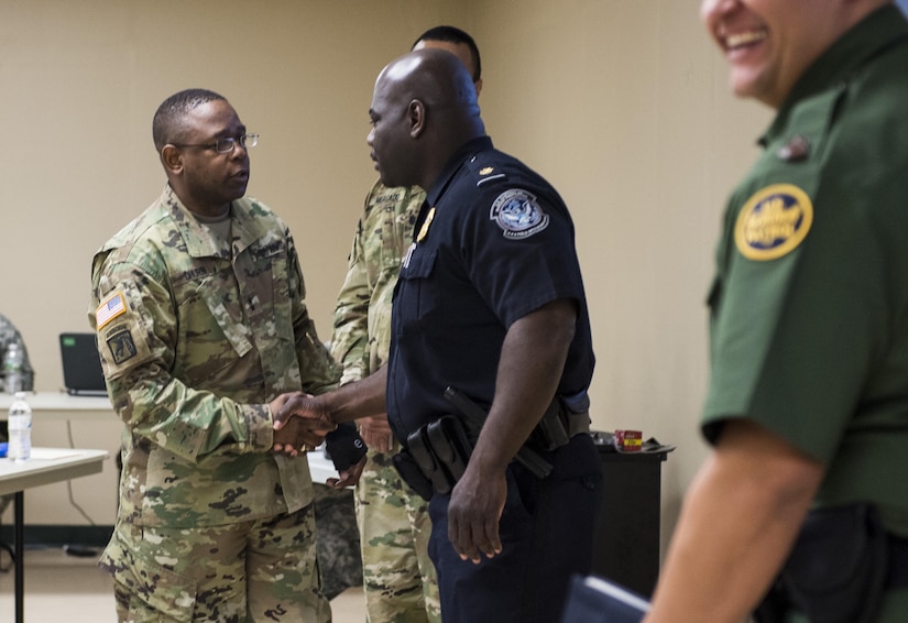 Maj. Gen. Phillip Churn, commanding general of the 200th Military Police Command, shakes hands with Supervisory Customs & Border Protection (CBP) Officer, Marecus Matthews, after he and another CBP officer provided a briefing on the career opportunities available to U.S. Army Reserve military police Soldiers at the MP command's headquarters at Fort Meade, Maryland, April 16. (U.S. Army photo by Master Sgt. Michel Sauret)