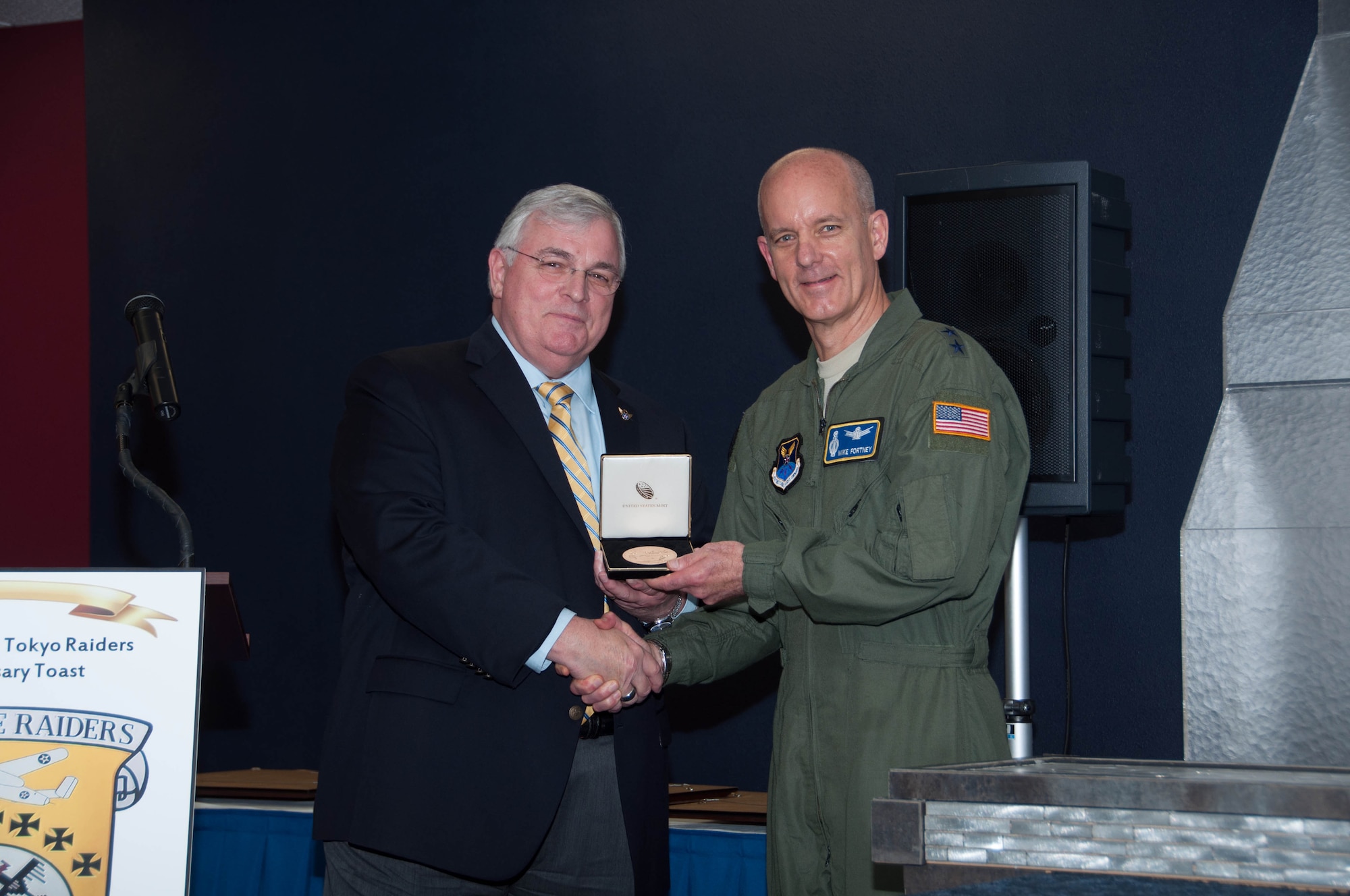 Mr. William Callaway, 8th Air Force Historian, presents Major General Michael Fortney, Air Force Global Strike Command vice commander, Barksdale Air Force Base, La, April 18, 2016, with a replica of the Congressional Gold Medal that was given to the Doolittle Raiders. It is the highest civilian honor Congress can give. The medal will be on display at the 8th Air Force Museum at Barksdale Air Force Base, La. (U.S. Air Force photo by Master Sgt. Laura Siebert/Released)