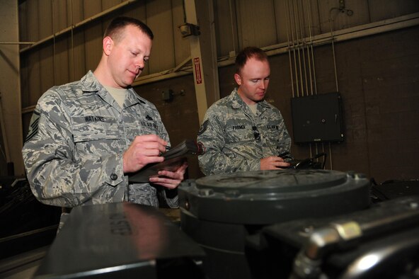 Master Sgt. Caleb Watkins, left, and Tech. Sgt. Jaime Farmer, both aircraft armament systems technicians assigned to the 131st Aircraft Maintenance Squadron, prep a munitions handling unit trailer for loading procedures at Whiteman Air Force Base, Missouri, April 14, 2016. Watkins and Farmer are two of three 131st AMXS drill-status guardsmen who loaded weapons to the B-2 Spirit during Exercise Constant Vigilance 16. (U.S. Air Force photo by Airman 1st Class Keenan Berry)