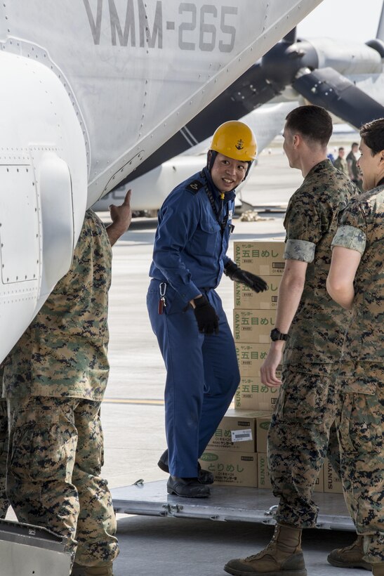 U.S. Marines and Japanese service members load supplies into a U.S. Marine Corps MV-22B Osprey aircraft at Marine Corps Air Station Iwakuni, Japan, April 20, 2016. Marine Corps photo by Cpl. Nathan Wicks