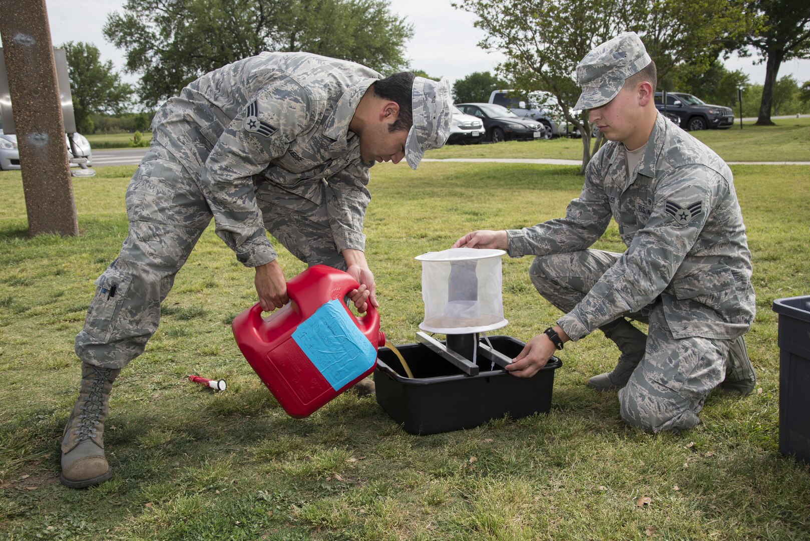 Senior Airmen Timothy Legge (left) and Ernesto Arguelles Jr., 359th Aerospace Medicine Squadron public health technicians, set a mosquito trap April 7 at Joint Base San Antonio-Randolph. When samples are collected, female mosquitoes are separated from the males and sent to the Army Public Health Command Central at JBSA-Fort Sam Houston to see if they are carrying disease-causing viruses. 