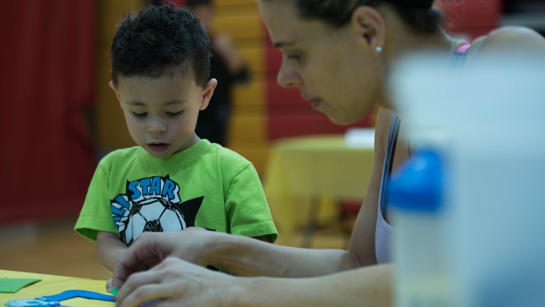 A mother and son work on some arts and craft while a the Children’s Fair at Henderson Hall in Arlington, Va. April 16, 2016. The Children’s Fair is a way of showing support for military children and parents. 