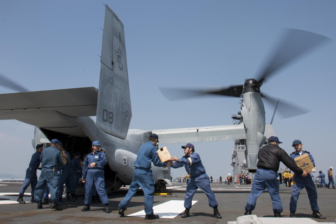 Japan Maritime Self-Defense Force members load earthquake relief supplies into a U.S. Marine Corps MV-22B Osprey aircraft aboard the JS Hyuga near Kumamoto, Japan, April 19, 2016. The U.S. military is providing relief support to the government of Japan following devastating earthquakes near Kumamoto. Navy photo by Petty Officer 3rd Class Gabriel B. Kotico
