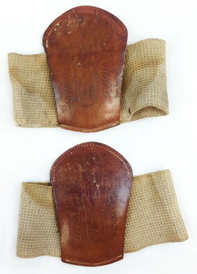 Combat boots during World War I tended to lack the cushion and shock absorption that modern-day combat boots are designed to have. These metatarsal pads were worn with the elastic strap over the top of one’s foot. They hold the pad in place over the bottom and just behind the ball of the foot at the arch that runs across the width of the foot. These pads provided comfort and helped prevent pain and numbness caused by overextension of the toes and arch during long marches and constant standing. These WWI pads are leather stuffed with cloth and batting. (U.S. Air Force photo)
