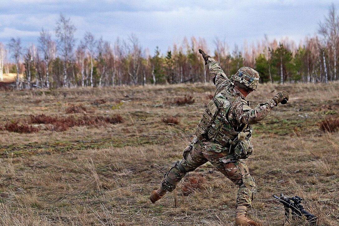 A U.S. soldier prepares to throw a smoke grenade to provide concealment for the team during the live-fire portion of a breaking contact and trench clearing exercise, part of Summer Shield XIII at Adazi Military Base, Latvia, April 19, 2016. Army photo by Sgt. Paige Behringer

