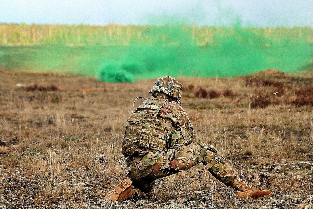 A U.S. soldier provides suppressive fire on a simulated enemy after throwing a smoke grenade to provide concealment for his team during the live-fire portion of an exercise as part of Summer Shield XIII at Adazi Military Base, Latvia, April 19, 2016. Army photo by Sgt. Paige Behringer