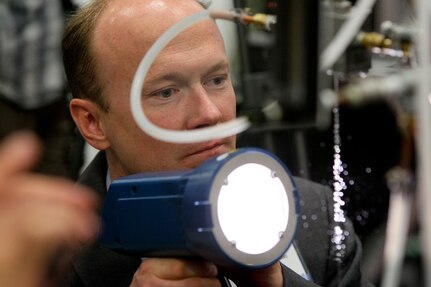 160217-N-HW977- SAN DIEGO, Calif. (Feb. 17, 2015) Dr. Aaron Wiest, a Naval Surface Warfare Center (NSWC), Corona Division physicist, points a strobe light at bubble-filled water droplets during WEST 2016, a three-day conference co-sponsored by Armed Forces Communications and Electronics Association (AFCEA) and U.S. Naval Institute (USNI). Earlier Rear Adm. Lorin Selby, NSWC commander, highlighted the intellectual capital of the warfare centers and their capability to deliver innovative technology to the warfighter. (U.S. Navy photo by Greg Vojtko/Released)