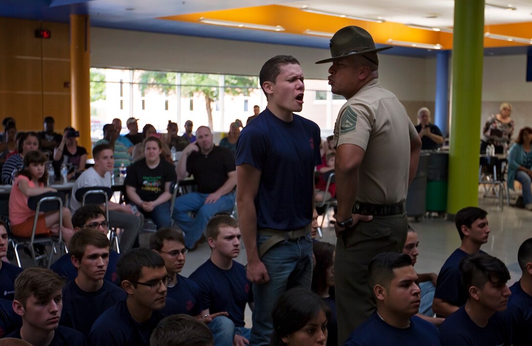 A poolee from Recruiting Sub-Station Fort Worth gets told to scream louder by a drill instructor during the annual pool function family night at Brewer High School in Fort Worth, Texas, April 19, 2016. More than 100 poolees and family members from the metropolitan area attended the family night to prepare them for Marine Corps recruit training.