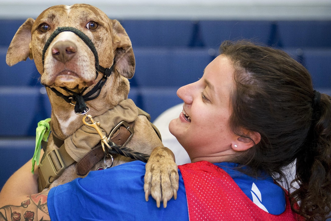 Hanna Stulberg, a Warrior Games athlete, and her military working dog, Valhalla, share a moment during the adaptive sports camp at Eglin Air Force Base, Fla., April 5, 2016. Air Force photo by Samuel King Jr.