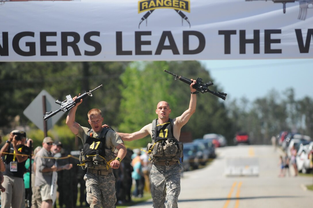 Army Staff Sgt. Erich Friedlein, left, and Capt. Robert Killian cross the finish line as the winners of the grueling three-day Best Ranger Competition at Fort Benning, Ga., April 17, 2016. DoD photo by Katie Lange
