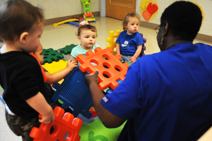 Donna Marshall, Child Development Center child care provider, helps children build furniture with Waffle Blocks at Barksdale Air Force Base, La., April 15, 2016. The CDCs and Youth Center will be holding the Give Parents a Break program on the second Friday of every month. (U.S. Air Force photo/Airman Alexis C. Frost)