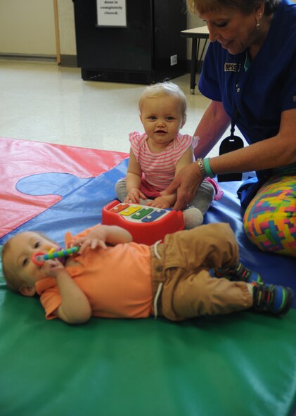 Bessie Roberts, Child Care Development Center child care provider, plays with children at Barksdale Air Force Base, La., April 15, 2016. The CDC specializes in child care for children who are six weeks old to five years of age. (U.S. Air Force photo/Airman Alexis Frost)
