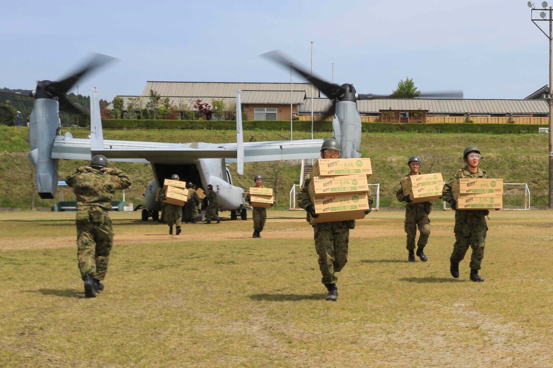 Japanese soldiers unload humanitarian aid from a U.S. Marine Corps MV-22B Osprey aircraft at the Hakusui Sports Park, Kyushu Island, Japan, April 20, 2016. The Marines and aircraft are assigned to Marine Medium Tiltrotor Squadron 265, 31st Marine Expeditionary Unit. The humanitarian aid is part of relief efforts after a series of earthquakes struck the island. Marine Corps photo by Cpl. Darien J. Bjorndal