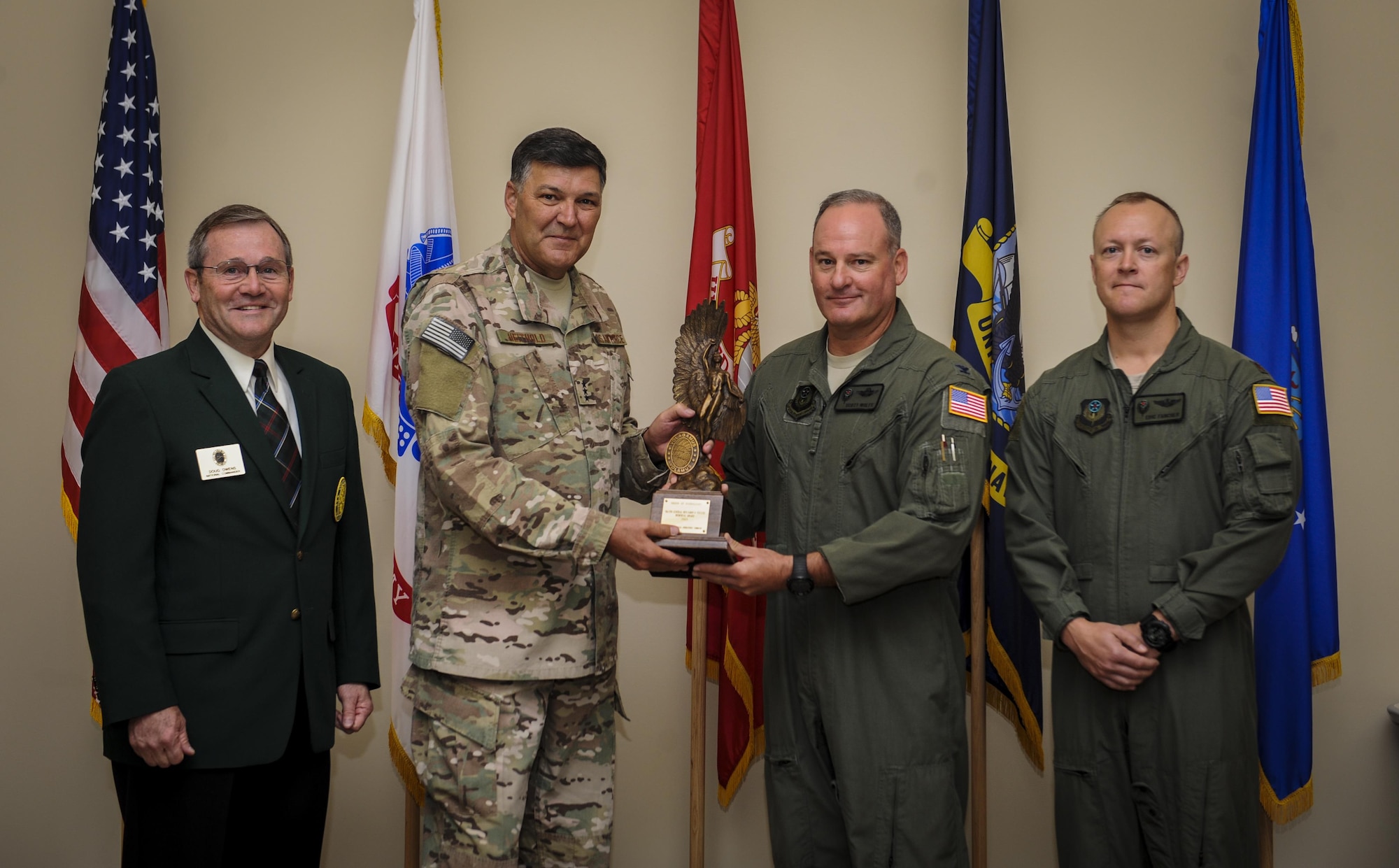 Lt. Gen. Brad Heithold, commander of Air Force Special Operations Command, presents the Foulois award to Col. William Wolfe, AFSOC safety director, at Hurlburt Field, Fla., April 20, 2016. Retired Lt. Gen. Doug Owens (far left), presented the award to AFSOC on behalf of the Order of Daedalians. Maj. Eric Francher (far right), AFSOC safety flight chief, joined Wolfe to accept the award. (U.S. Air Force photo by Senior Airman Meagan Schutter)   