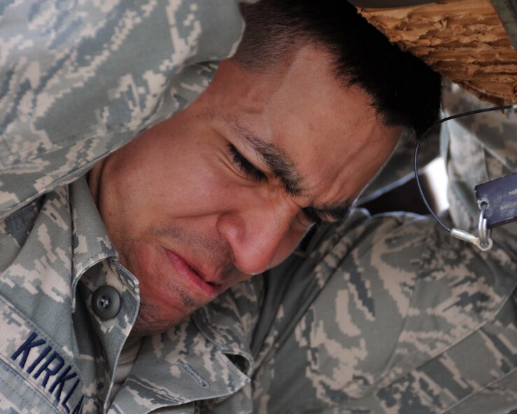 Senior Airman Randall Kirkland, 123rd Contingency Response Group air transportation specialist, pushes a Humvee into the cargo area of a C-130 Hercules at Aviano Air Base, Italy on April 10, 2016. The fully-armored Humvee weighed approximately 16,590 pounds and required a four-member load team to push it from the K-Loader onto the C-130.  (U.S. Air Force photo/ Senior Airman Andrew J. Park)
