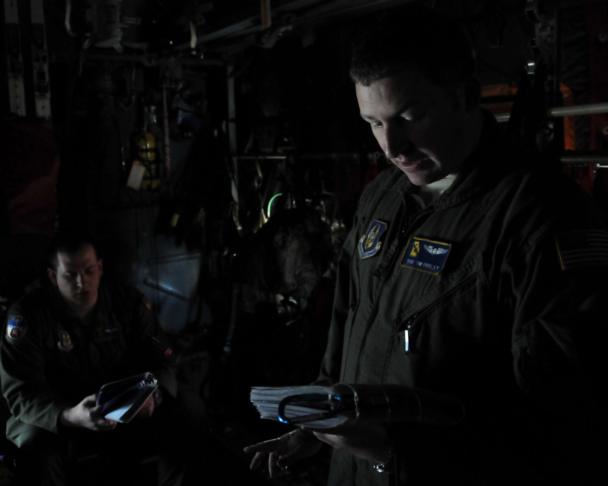 Staff Sgt. Tim Ousley, 700th Airlift Squadron loadmaster, briefs the airdrop checklist to SeniorAirman Brad Johnson, 700th AS loadmaster, in the cargo area of a C-130 Hercules at Aviano Air Base, Italy on April 11, 2016. The checklist provides a step-by-step process for preparing the C-130 for conducting airdrops. (U.S. Air Force photo/ Senior Airman Andrew J. Park)
