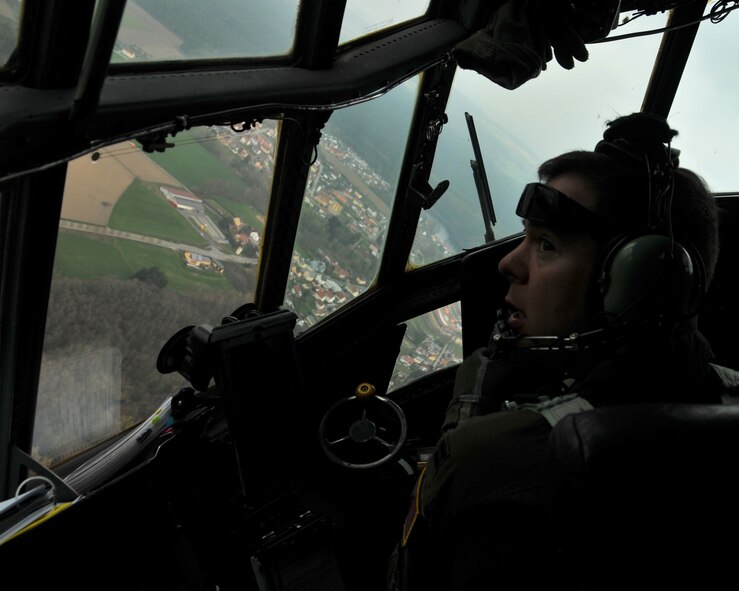 Capt. Mike Terrell, 700th Airlift Squadron C-130 instructor pilot, looks out the window of a C-130 Hercules as he makes a sharp turn flying over Germany on April 12, 2016. The C-130 made several passes over Hohenfels Training Area, Germany so that all the paratroopers could jump from the plane. (U.S. Air Force photo/ Senior Airman Andrew J. Park)
