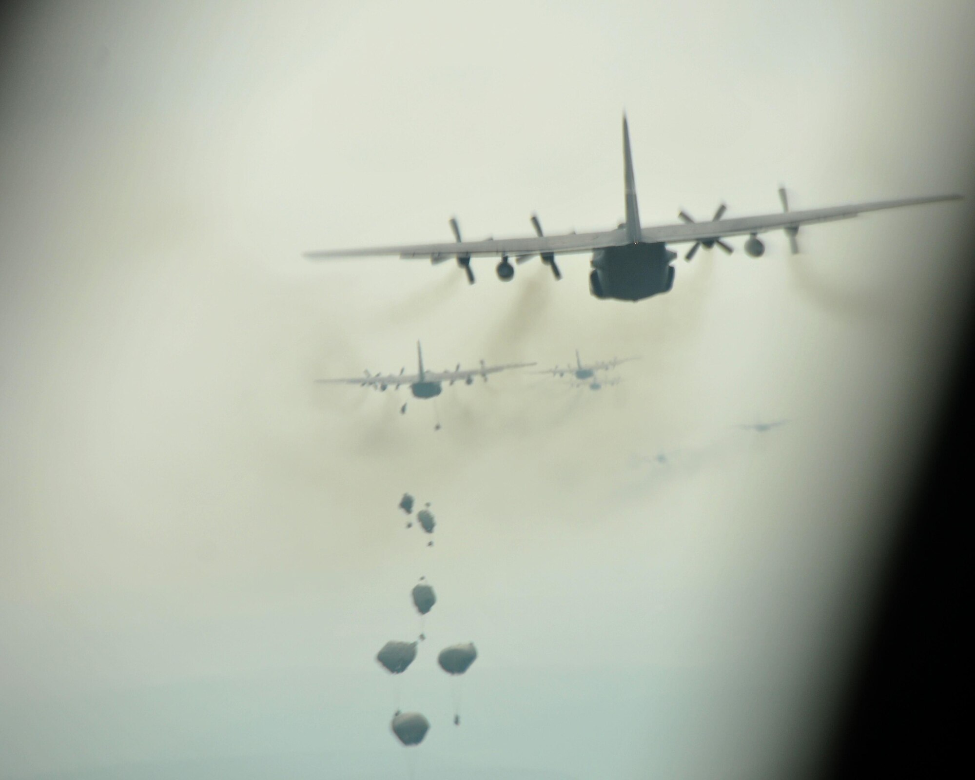 Paratroopers deploy their parachutes over Hohenfels Training Area, Germany on April 12, 2016. The 94th Airlift Wing participated in Exercise Saber Junction 16 April 11-15. (U.S. Air Force photo/ Senior Airman Andrew J. Park)
