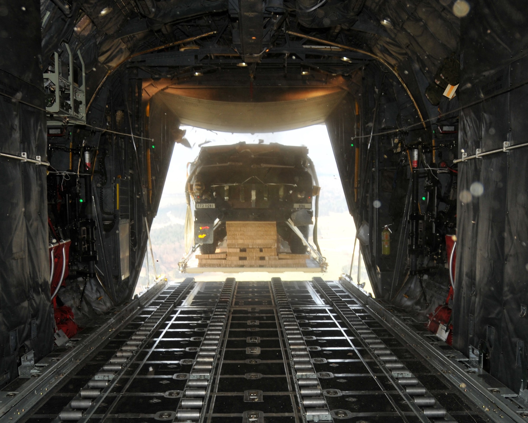 A Humvee is air dropped out of the back of a C-130 Hercules over Hohenfels Training Area, Germany on April 11, 2016. The 94th Airlift Wing participated in Exercise Saber Junction 16 April 11-15. (U.S. Air Force photo/ Senior Airman Andrew J. Park)
