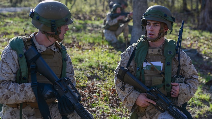 2nd. Lt. Benjamin Farmer, a student at the Marine Military Police Officers Basic Course, guides his squad in capturing a village at Fort Leonard Wood, Missouri, during a three-day field training exercise, Apr. 13, 2016. The new course allows officers to work closely with enlisted Marines to better prepare them for leading Marines in the fleet. (Official Marine Corps photo by Lance Cpl. Julien Rodarte/Released)