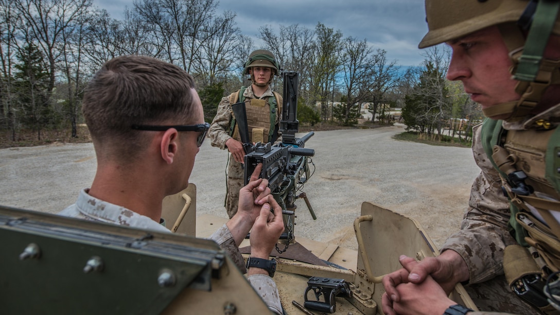 An instructor at the Marine Military Police Officers Basic Course teaches students proper weapons handling techniques during a three-day field training exercise at Fort Leonard Wood, Missouri, Apr. 13, 2016. Instructors continuously guide and train students on how to properly handle weapons throughout the course. (Official Marine Corps photo by Lance Cpl. Julien Rodarte/Released)