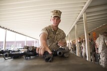 Corporal Spencer Diersing, 3rd Squad Team Leader, with 2nd platoon Charlie Company, Fleet Anti-Terrorism Security Team, Marine Corps Security Forces Regiment, prepares his weapons to be turned into the armory aboard Camp Allen, Norfolk, Virginia, 13 April, after returning from a four month deployment to Guantanamo Bay, Cuba. The Marines from Charlie Company posted security along the fence line and stood post in guard towers at Guantanamo Bay Naval Base, while conducting land navigation exercises, going to rifle and weapon ranges and engaging in weapons system sustainment training. (U.S. Marine Corps photo by Cpl. Calvin Shamoon/Unreleased)