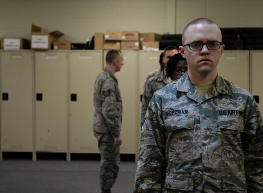 Tech. Sgt. Daniel Hill, 366th Force Support Squadron base honor guard flight chief, looks over potential honor guardsmen at Mountain Home Air Force Base, Idaho, March 3, 2016. Upon qualification the airmen will be on a one-year rotation as honor guardsmen. (U.S. Air Force photo by Senior Airman Jessica H. Evans/RELEASED)