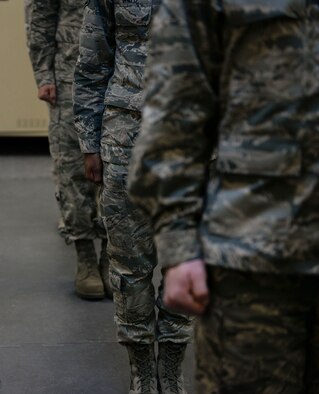 Potential honor guardsmen stand at attention in anticipation of the next command at Mountaion Home Air Force Base, Idaho, March 3, 2016. Honor guard not only reqires sharp movements, but also strict grooming standards from haircuts to ironed sand-tees. (U.S. Air Force photo by Senior Airman Jessica H. Evans/RELEASED)