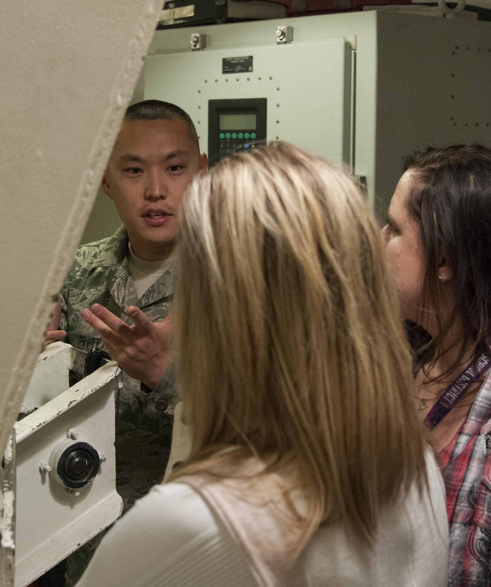 Staff Sgt. Adam Pruitt, 790th Maintenance Squadron missile maintenance technician topside instructor, discusses the maintenance mission with two local educators inside the U-01 Training Facility on F.E. Warren Air Force Base, Wyo., April 19, 2016. The goal of the tour was to better equip the educators to accommodate military children. (U.S. Air Force photo by Senior Airman Jason Wiese)
