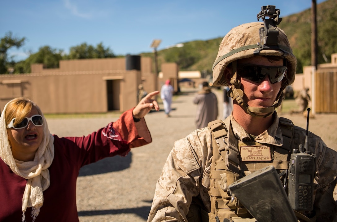 MARINE CORPS BASE CAMP PENDLETON, Calif. – Cpl. Jarod B. Hodge provides security while interacting with simulated local nationals as Marines from 7th Engineer Support Battalion conducted a simulated resupply at Camp Pendleton March 25, 2016. The convoy training consisted of three phases: Marines performing crowd control while refueling a patrol base, immediate action drills from hostile fire and casualty evacuation from a helicopter landing zone. Hodge, a native of Greenville, Indiana, is a combat engineer with 7th ESB, 1st Marine Logistics Group. (U.S. Marine Corps photo by Lance Cpl. Justin E. Bowles/ Released)