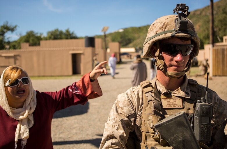 MARINE CORPS BASE CAMP PENDLETON, Calif. – Cpl. Jarod B. Hodge provides security while interacting with simulated local nationals as Marines from 7th Engineer Support Battalion conducted a simulated resupply at Camp Pendleton March 25, 2016. The convoy training consisted of three phases: Marines performing crowd control while refueling a patrol base, immediate action drills from hostile fire and casualty evacuation from a helicopter landing zone. Hodge, a native of Greenville, Indiana, is a combat engineer with 7th ESB, 1st Marine Logistics Group. (U.S. Marine Corps photo by Lance Cpl. Justin E. Bowles/ Released)