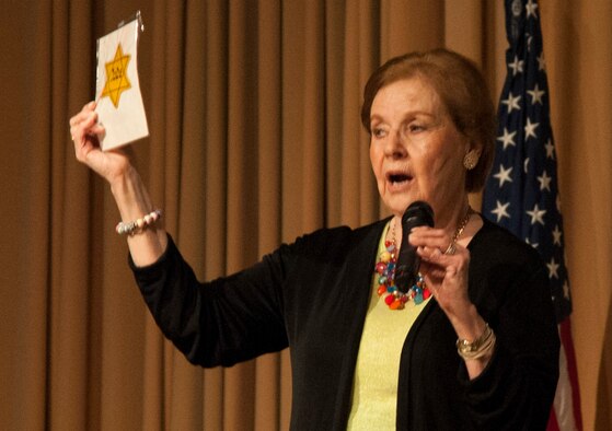 Marion Blumenthal Lazan, a survivor of the concentration camps and death trains of the Holocaust in Germany and Holland during World War II, shows an audience at Vance Air Force Base, Oklahoma, a yellow star she was forced to wear to show she was a Jew. She shared her story and memories with the men and women of Team Vance April 13 in the base auditorium. (U.S. Air Force photo/ Tech. Sgt. James Bolinger)