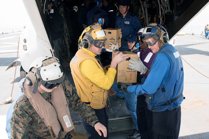 YATSUSHIRO BAY, Japan (April 20, 2016) - Sailors and Marines load supplies onto an MV-22 Osprey alongside members of the Japan Maritime Self-Defense Force (JMSDF) aboard the destroyer helicopter ship JS Hyuga (DDH) 181. At the request of the Japanese government, U.S. Forces Japan is providing airlift support to Japanese Self-Defense Forces (JSDF). A JSDF task force of more than 25,000 personnel is providing humanitarian and disaster relief assistance to the people affected by the magnitude 6.5 and 7.3 earthquakes that struck the Kumamoto area on April 14 and 16. 
