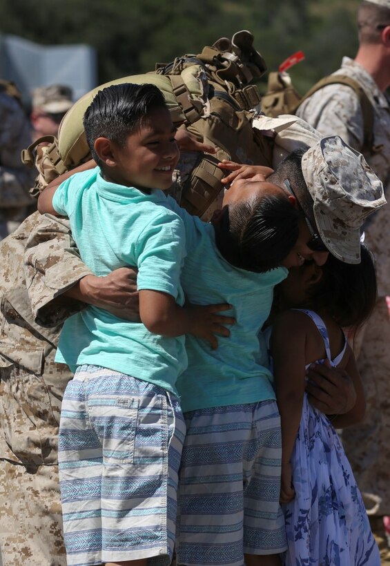 MARINE CORPS BASE CAMP PENDLETON, Calif. – Staff Sgt. Damian Fonseca, a training chief with Special Purpose Marine Air-Ground Task Force - Crisis Response - Central Command 16.1, from Modesto, Calif., embraces his children at a homecoming ceremony on Camp Pendleton April 17, 2016. SPMAGTF-CR-CC is a rotational contingent of approximately 2,300 Marines and sailors sourced from units throughout I Marine Expeditionary Force. This unit has become an integral part of Operation Inherent Resolve, providing kinetic and non-kinetic strike capabilities, aviation logistics support to operations across Iraq, a dedicated Tactical Recovery of Aircraft and Personnel force, and the security forces aboard Al-Taqaddum Air Base and Al Asad Air Base, Iraq. (U.S. Marine Corps photo by Cpl. Angel Serna/Released)