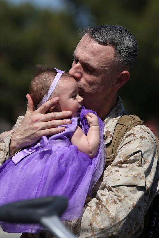MARINE CORPS BASE CAMP PENDLETON, Calif. – Lieutenant Col. Glenn Savage, the air integration section head with Special Purpose Marine Air-Ground Task Force - Crisis Response - Central Command 16.1, embraces his daughter at a homecoming ceremony on Camp Pendleton April 17, 2016. SPMAGTF-CR-CC is a rotational contingent of approximately 2,300 Marines and sailors sourced from units throughout I Marine Expeditionary Force. This unit has become an integral part of Operation Inherent Resolve, providing kinetic and non-kinetic strike capabilities, aviation logistics support to operations across Iraq, a dedicated Tactical Recovery of Aircraft and Personnel force, and the security forces aboard Al-Taqaddum Air Base and Al Asad Air Base, Iraq. (U.S. Marine Corps photo by Cpl. Angel Serna/Released)