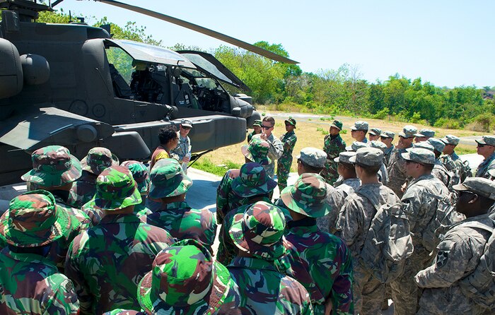In this file photo, Chief Warrant Officer Two Jake Uber with the 1st Battalion, 25th Aviation Regiment, 25th Combat Aviation Brigade out of Fort Carson, Colo., gives Soldiers from the 2nd Battalion, 1st Infantry Regiment, 2nd Stryker Brigade Combat Team, 2nd Infantry Division, and Indonesian Armed Forces' 411th Raider Infantry Battalion, a AH-64 Apache familiarization briefs during Garuda Shield 2014. The exercise is a bilateral, tactical military exercise sponsored by U.S. Army Pacific Command and hosted by the Indonesian armed forces. Approximately 1,200 personnel from U.S. Army and Indonesian Armed Forces will conduct a series of training events focused on peace support operations. 