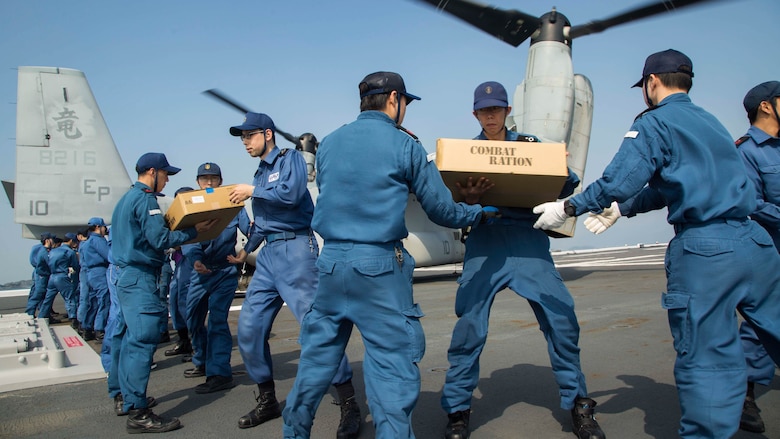 U.S. Marines assigned to Marine Medium Tiltrotor Squadron 265 (Reinforced), 31st Marine Expeditionary Unit, and Japan Self-Defense Force members transport supplies onto an MV-22B Osprey aboard the JS Hyuga (DDH 181), April 19, 2016. The supplies are in support of the relief effort after a series of earthquakes struck the island of Kyushu. The 31st MEU is the only continually forward-deployed MEU and remains the Marine Corps' force-in-readiness in the Asia-Pacific region. 