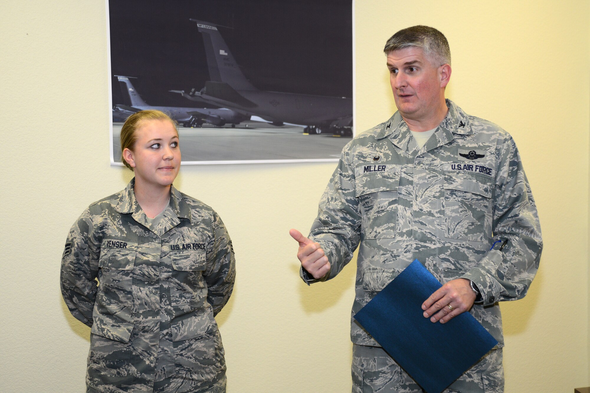 Col. Albert Miller, right, 22nd Air Refueling Wing commander, speaks of Senior Airman Jacquelyn Yenser, 22nd Director of Staff wing administrator, accomplishments, April 15, 2016, at McConnell Air Force Base, Kan. Yenser received the spotlight performer for the week of Feb. 8 - 12, but she was attending Airman Leadership School. (U.S. Air Force photo/Airman 1st Class Christopher Thornbury)