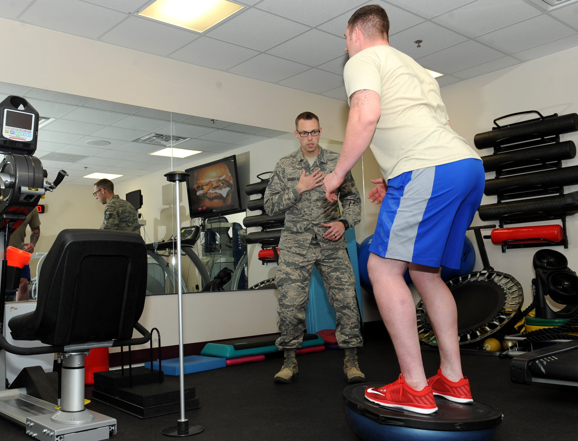 Tech. Sgt. Sean Devereaux, 22nd Medical Operations Squadron NCO in charge of physical training, helps an Airman with his balance, April 19, 2016, at McConnell Air Force Base, Kan. The medical group is approaching health care in a more proactive way by performing lower extremity screenings and analyzing the way Airmen walk or run in order to prevent future problems. (U.S. Air Force photo/Senior Airman David Bernal Del Agua)