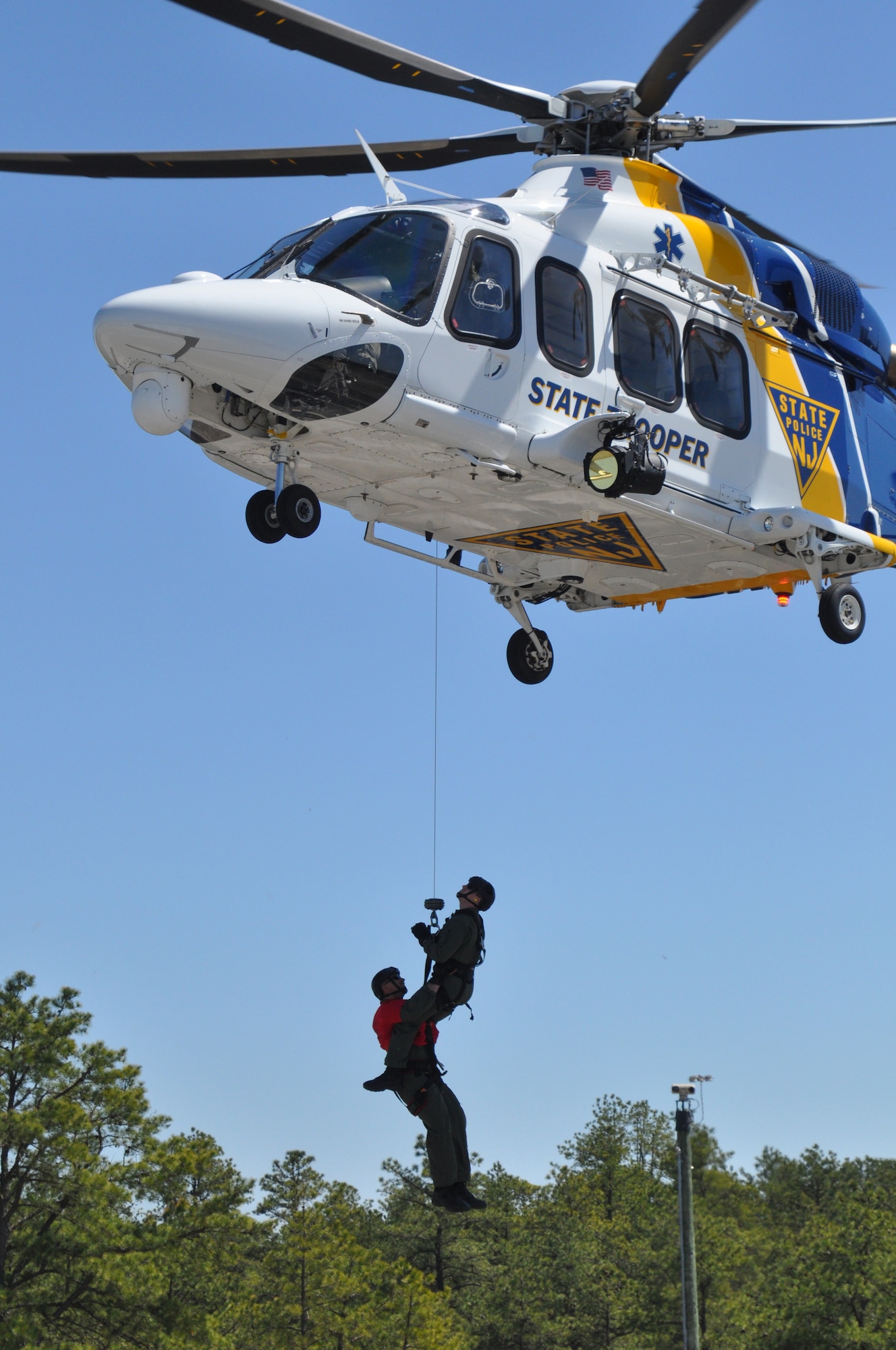 The New Jersey Army National Guard aviation team tested their ability to move people and equipment to where they are needed in a natural disaster on April 16-17, 2016 at Joint Base-McGuire-Dix-Lakehurst, N.J. The 150th Assault Helicopter Battalion used a pair of UH-60 Black Hawk helicopters to airlift 40 members of the New Jersey Task Force 1 urban search and rescue unit from their headquarters on Lakehurst to the range area of JB MDL. Along for the ride were several live-find canines joining the task force volunteers. During the exercise, the aviators sling loaded a box of search and rescue equipment for the New Jersey State Troopers assigned to the Office of Emergency Management. A UH-72 Lakota helicopter from the 1-224th Security and Support Battalion flew overhead to provide aerial reconnaissance for the search and rescue exercise. The weekend event is the first for Operation Derecho as several training exercises are planned for the year.
(Photos by 1st Sgt. Kryn Westhoven and Sgt. Jorge Morales)

