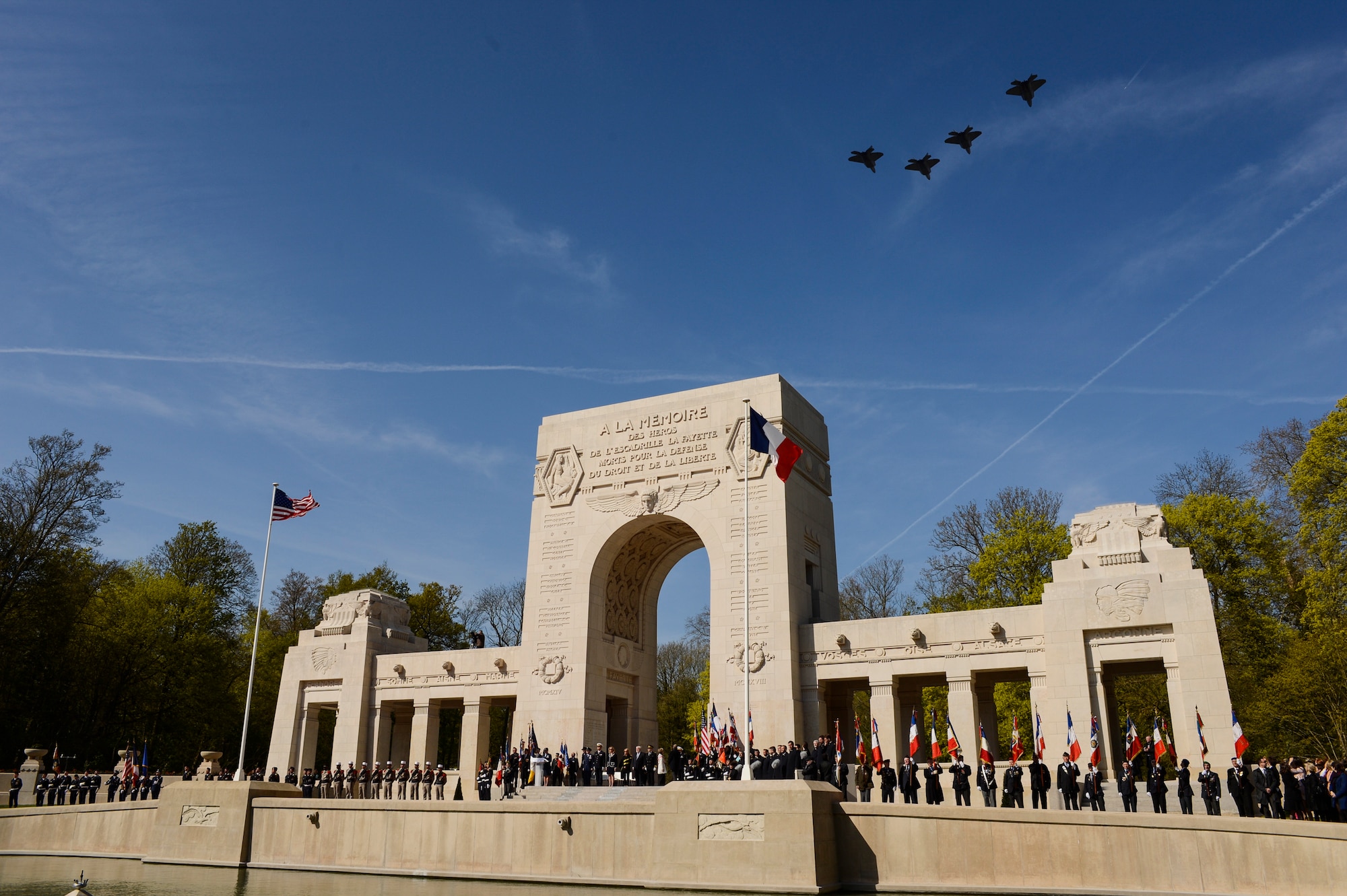 PARIS – Four U.S. Air Force F-22 Raptor fifth generation fighters fly over the Lafayette Escadrille Memorial in Marnes-la-Coquette, France, April 20, 2016, during a ceremony honoring the 268 Americans who joined the French Air Force before the U.S. officially engaged in World War I. In addition to the F-22s, a USAF B-52 Stratofortress bomber, three FAF Mirage 2000Ns, one FAF Rafale and a World War I-era Stearman PT-17 biplane performed flyovers during the ceremony commemorating the 100th anniversary of the Layfette Escadrille’s formation. Men of the Lafayette Escadrille and Lafayette Flying Crops were critical to the formation of the U.S. Air Force. (U.S. Air Force Photo by Tech. Sgt. Joshua DeMotts/Released)