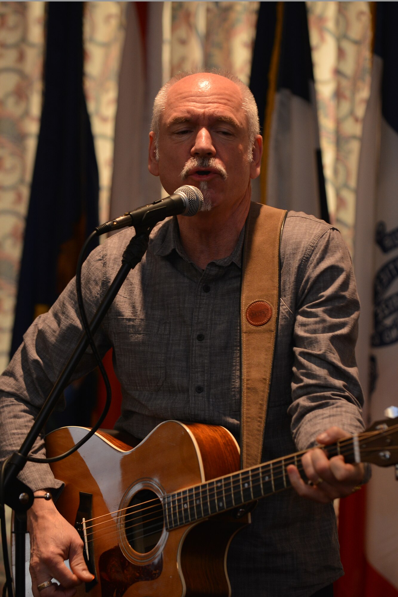 Danny Bryam, guest speaker, sings before giving a speech during the National Prayer Breakfast at Fort Eustis, Va., April 15, 2016. Throughout his career, Bryam has coordinated with military chaplains to bring inspirational music and messages to U.S. Service members and their families. (U.S. Air Force photo by Staff Sgt. Natasha Stannard)