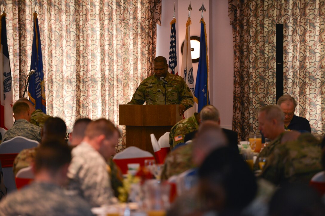 U.S. Army Chaplain (Lt. Col.) Juan Crockett, command chaplain for Center for Initial Military Training, leads prayer for national leaders during the National Prayer Breakfast at Fort Eustis, Va., April 15, 2016. During the event, U.S. Army and Air Force members joined one another in giving thanks and praise to those who fought and continue to fight for the nation and its allies. (U.S. Air Force photo by Staff Sgt. Natasha Stannard)