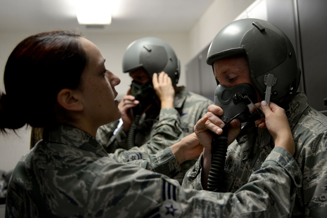 U.S. Air Force Senior Airman Francia Holt, an aerospace and operational physiology technician assigned to 633rd Aerospace Medicine Squadron, adjusts the straps on a Reduced Oxygen Breathing Device at Langley Air Force Base, Va., April 19, 2016. Aerospace physiologists ensure aircrew members understand the potential threats oxygen deprivation and depressurization have on the body. (U.S. Air Force photo by Airman 1st Class Kaylee Dubois)