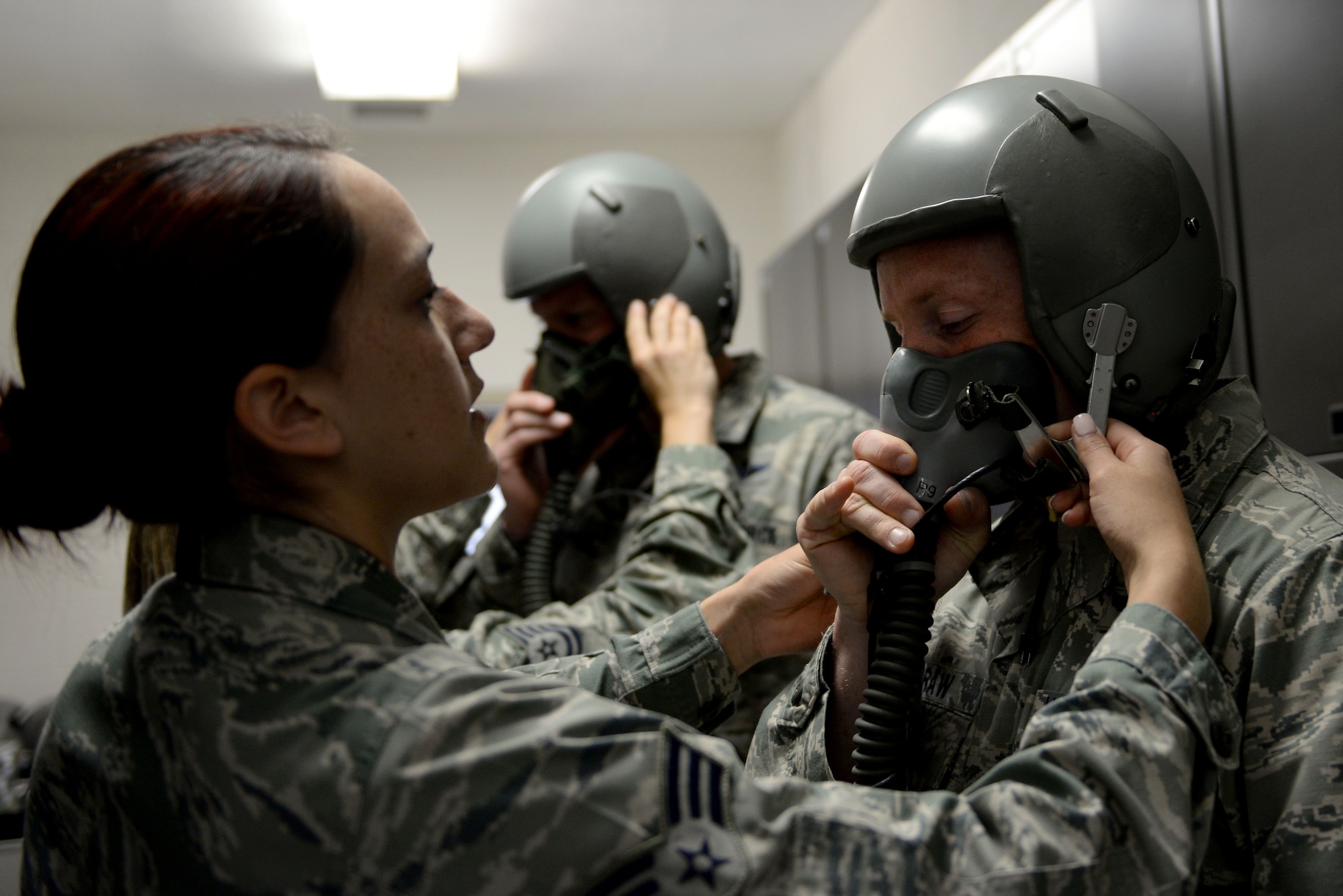 U.S. Air Force Senior Airman Francia Holt, an aerospace and operational physiology technician assigned to 633rd Aerospace Medicine Squadron, adjusts the straps on a Reduced Oxygen Breathing Device at Langley Air Force Base, Va., April 19, 2016. Aerospace physiologists ensure aircrew members understand the potential threats oxygen deprivation and depressurization have on the body. (U.S. Air Force photo by Airman 1st Class Kaylee Dubois)