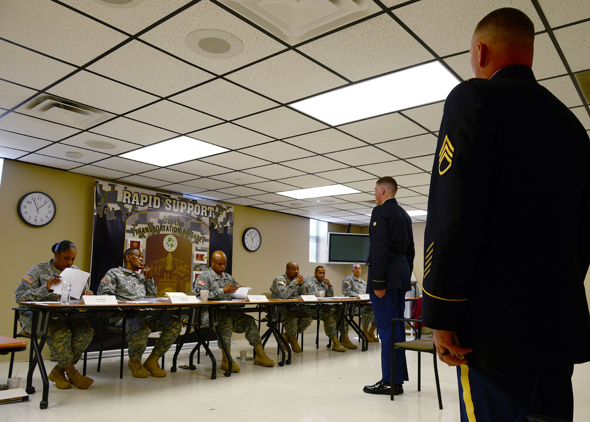 U.S. Army Spc. David Dell, a cargo specialist assigned to the 689th Rapid Port Opening Element, reports to the command sergeant major and first sergeant’s board during the 597th Transportation Brigade Best Warrior competition at Fort Eustis, Va., April 15, 2016. The evaluation board was compromised of battalion command sergeant majors and first sergeants. (U.S. Air Force photo by Staff Sgt. J.D. Strong II)