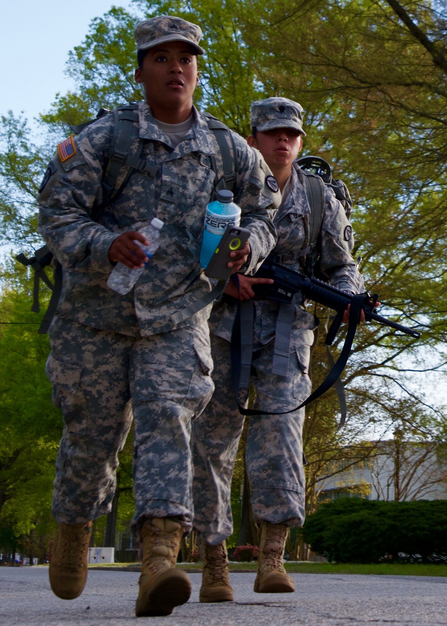 U.S. Army Sgt. Anais Fisher, a motor transport operator rucks with her sponsored Soldier, Spc. Diamantina Hernandez, a cargo specialist assigned to the 690th Rapid Port Opening Element, during the 597th Transportation Brigade Best Warrior Competition at Fort Eustis, Va., April 15, 2016. Each Soldier marched 12 miles wearing a ruck sack weighing 35 pounds. and an M-4 carbine. (U.S. Air Force photo by Staff Sgt. J.D. Strong II)